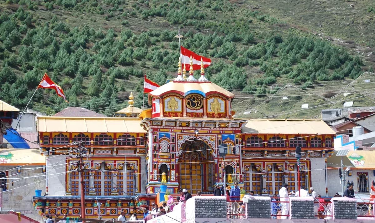 Vibrant painted facade of Badrinath Temple with the Alaknanda river valley behind
